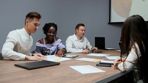 Diverse Team Collaborating During Business Meeting Presentation