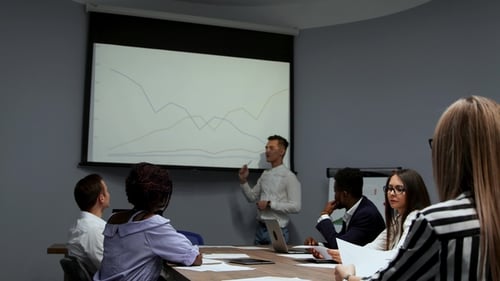 Professionals Collaborate at Conference Table Meeting