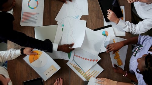 Top View of the Large Desk Behind Which the Office Team of Creative Managers of Different