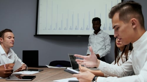 African American Coach Gives Corporate Presentation for Businesspeople in Office, Dark Skinned