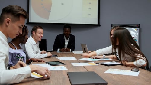 Diverse Team Discussing Business Around Conference Table