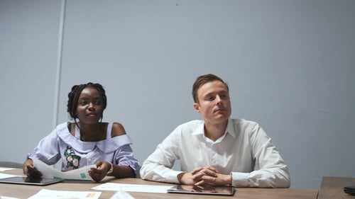 African American Coach Gives Corporate Presentation for Businesspeople in Office