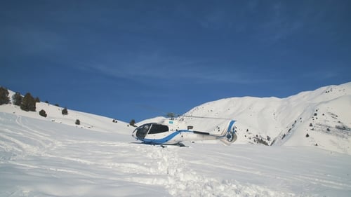 Helicopter on Snowy Mountain with Rotor Turning
