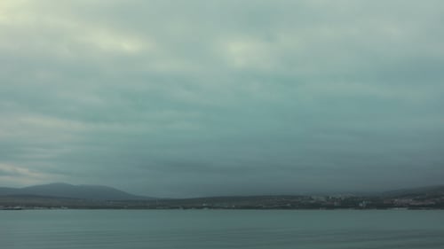 Evening Sky Over Northern City and Sea