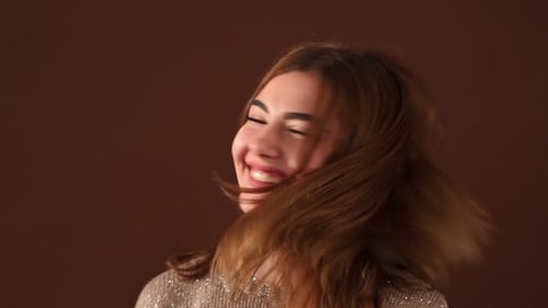 Portrait of Girl with Long Waving Hair in Studio