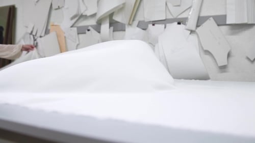 Clothing Designer Working with Measurements on a Studio Table