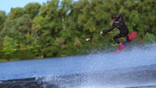 Man Wakeboarder Making Tricks on Water. Man Falling Down in Water