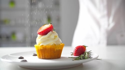Cupcake Topped with Strawberry and Sprinkled with Powder