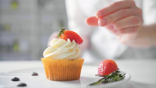 Vanilla Cupcake Decorated with Strawberry and Rosemary