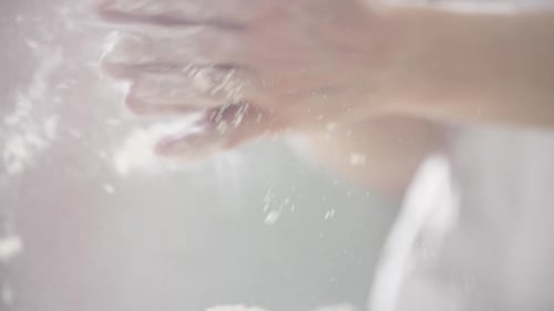 Hands Clapping Covered in Flour Dust