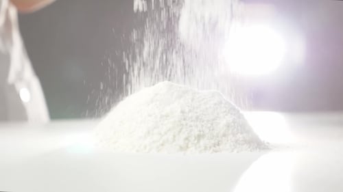 Flour Being Poured Onto a White Surface