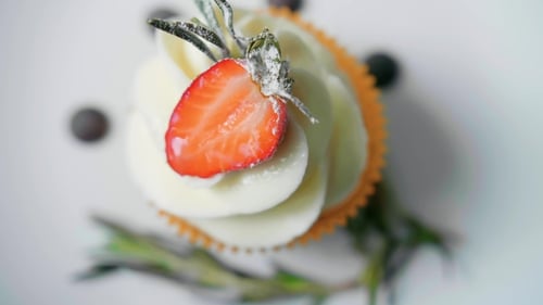 Delicious Cupcake with Strawberry and Rosemary Garnish