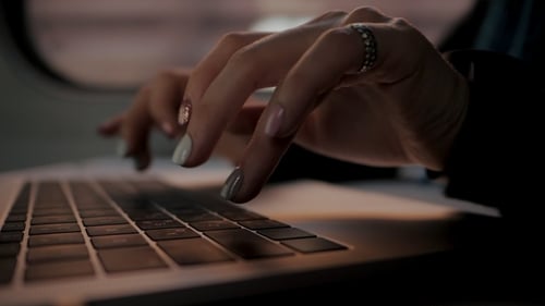 Close Up of Hands Typing on Laptop Keyboard