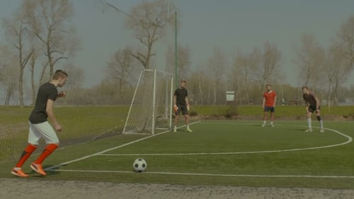 Handsome Soccer Player Hitting Ball with Head