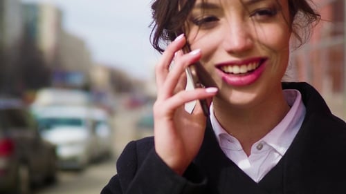 Happy, Smiling, Cheerful, Ironical Girl Be Using the Cell Phone, She Has an Excited Conversation