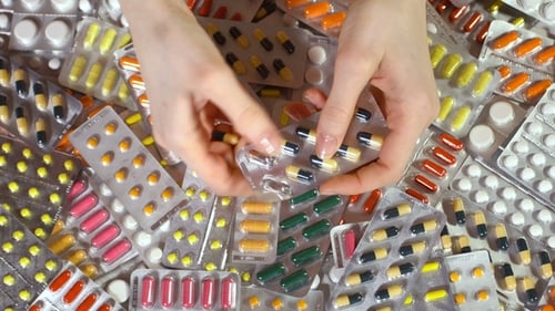 Hands Taking Pills From Blister Pack, Close Up