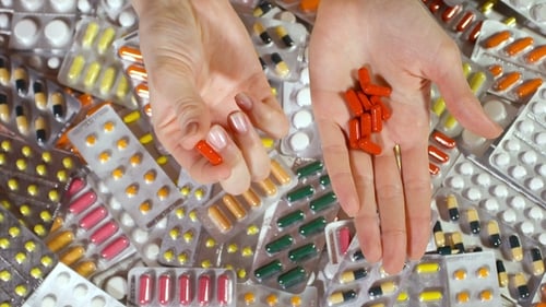 Holding Red Pills with Blister Packs Background