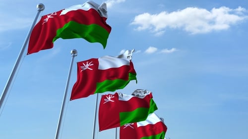 Omani Flags Waving in the Wind with Blue Sky