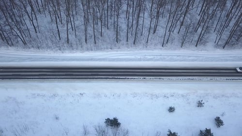 Car Driving Through Winter Forest Road