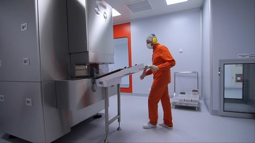 Factory Worker Starting Work with Pharmaceutical Packaging Machine at Factory