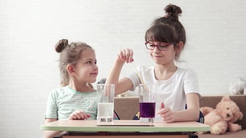 Girls Doing Science Experiment With Liquids