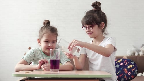 Enthusiastic Girls Conduct Science Experiment with Liquids