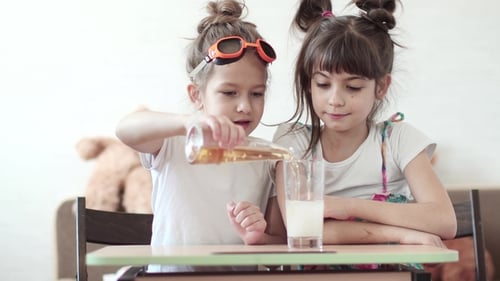Young Girls Mixing Liquids for Fun Science Experiment