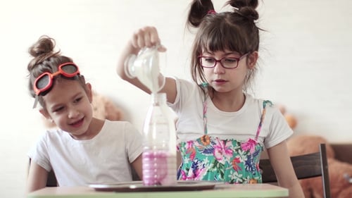 Excited Girls Pour Liquid for Chemistry Experiment
