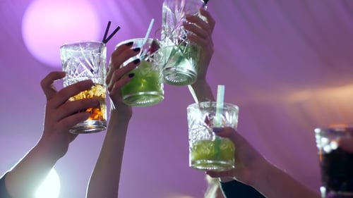Friends Toasting Drinks at a Vibrant Nightclub