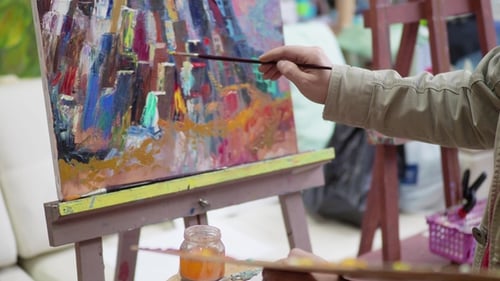 Artist Painting Colorful Abstract Artwork in Art Studio