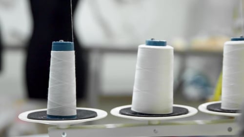 White Thread Spools on Sewing Machine