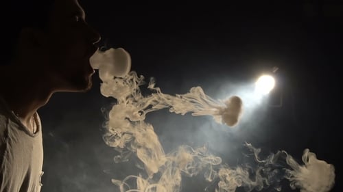 Smoke Rings Against Dark Background