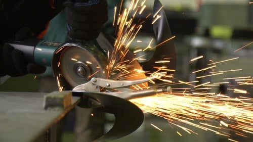 Man Works Circular Saw. Flies of Spark From Hot Metal.