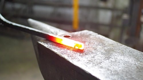 Blacksmith Hammering Hot Metal on Anvil Close Up