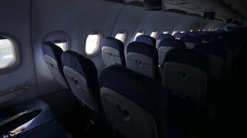 Looking Out the Window of an Airplane As Clouds Pass By