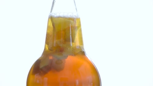 Close up of a drink with fruit in bottle