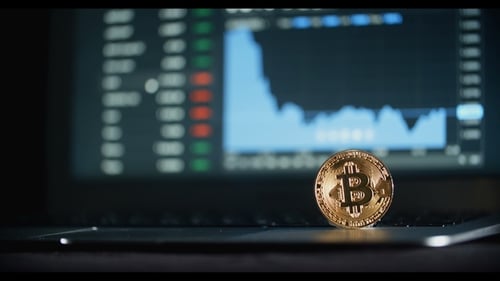 Bitcoin Coin on Laptop with Stock Chart Display