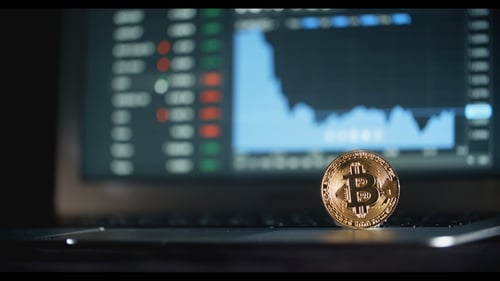 Cryptocurrency Coin on Laptop with Chart