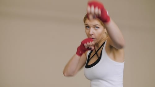 Focused Woman Boxing, Practicing Punches