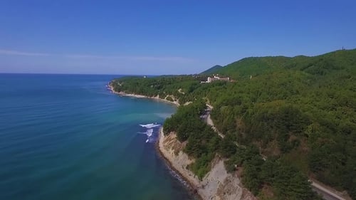 Video From the Drone Flying Along the Coast. A Road Passes Along the Shore.