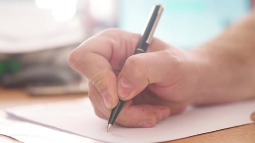 Hand Writing on Paper with Pen Close Up