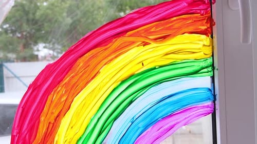 Painted Rainbow on Window with Paints and Brushes