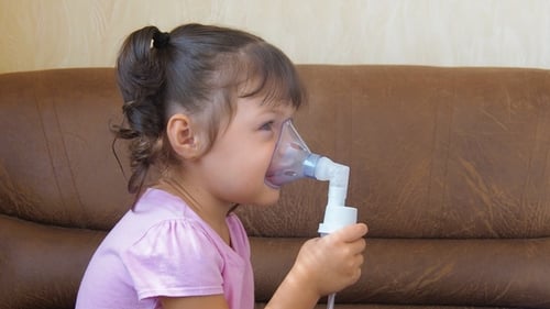 Girl Using Nebulizer Mask at Home
