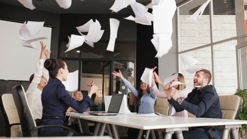 Team Celebrates Success by Throwing Papers in Air