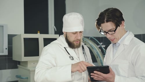 Two Doctors Consulting Using Tablet in the Clinic