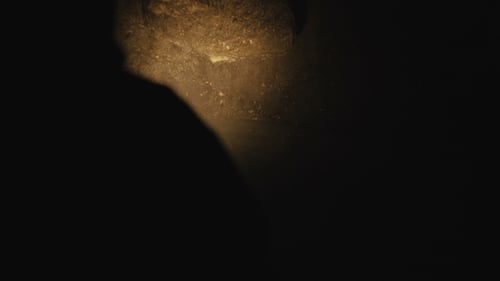 View of Flashlight's Shadow in Darkness of the Ancient Stone Cave