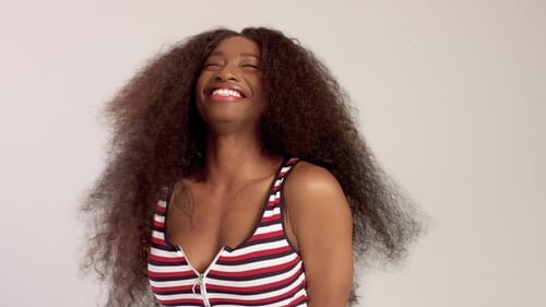 Beauty Black Mixed Race African American Woman with Long Curly Hair and Perfect Smile