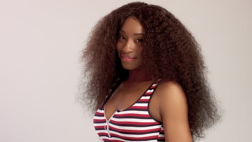 Woman With Long Curly Hair Smiles and Laughs
