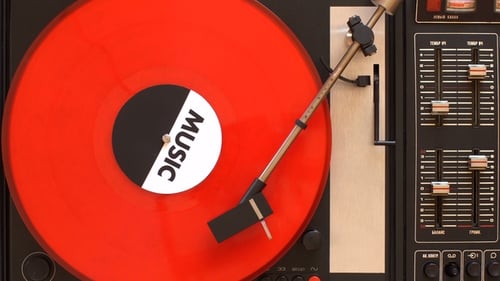 A Record Player Turntable with It's Stylus Running along a Vinyl Record