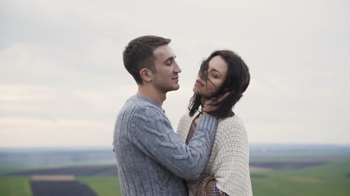 Romantic Couple in Embracess and Kisses Stand on the Top of Rock